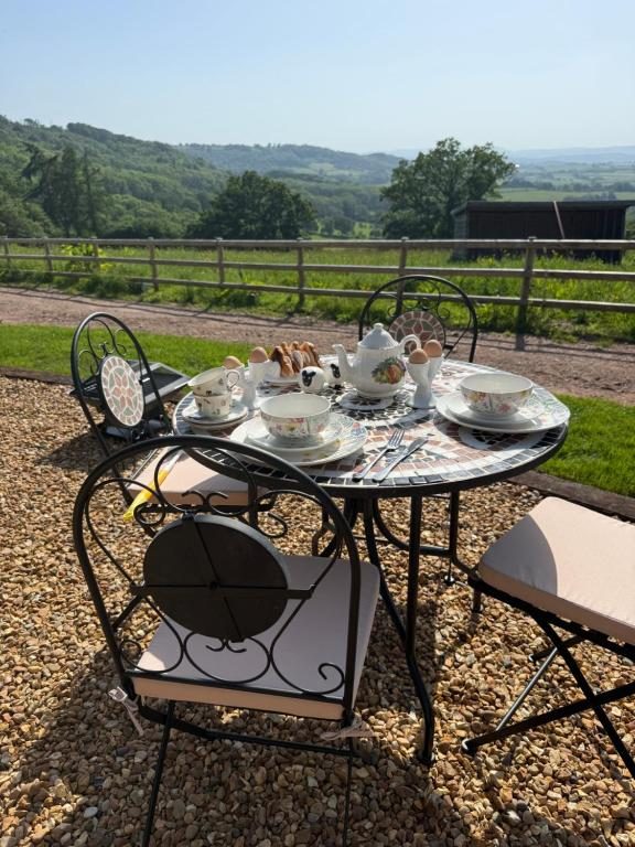 Breakfast laid out on the terrace with the valley behind