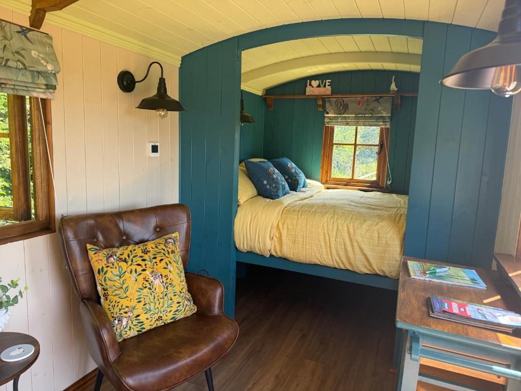 Sunlit armchair and the bed alcove inside the hut