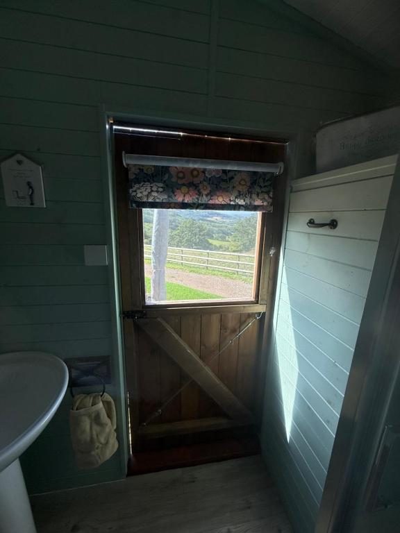 The stable door open onto the valley